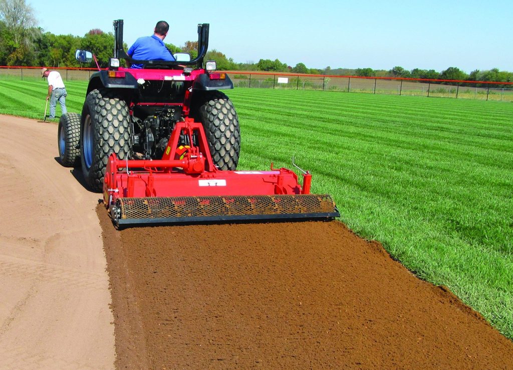 back view of gentleman on machine on baseball field