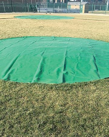 green tarp on the pitcher mount