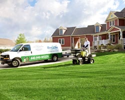 employee riding on machine on lawn 