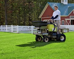 gentleman riding machine on lawn 