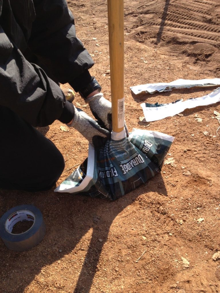gentleman opening bag of fertilizer up