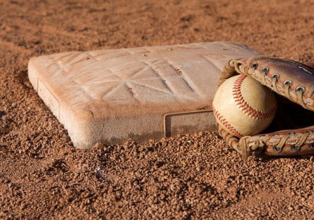 Baseball and glove near base