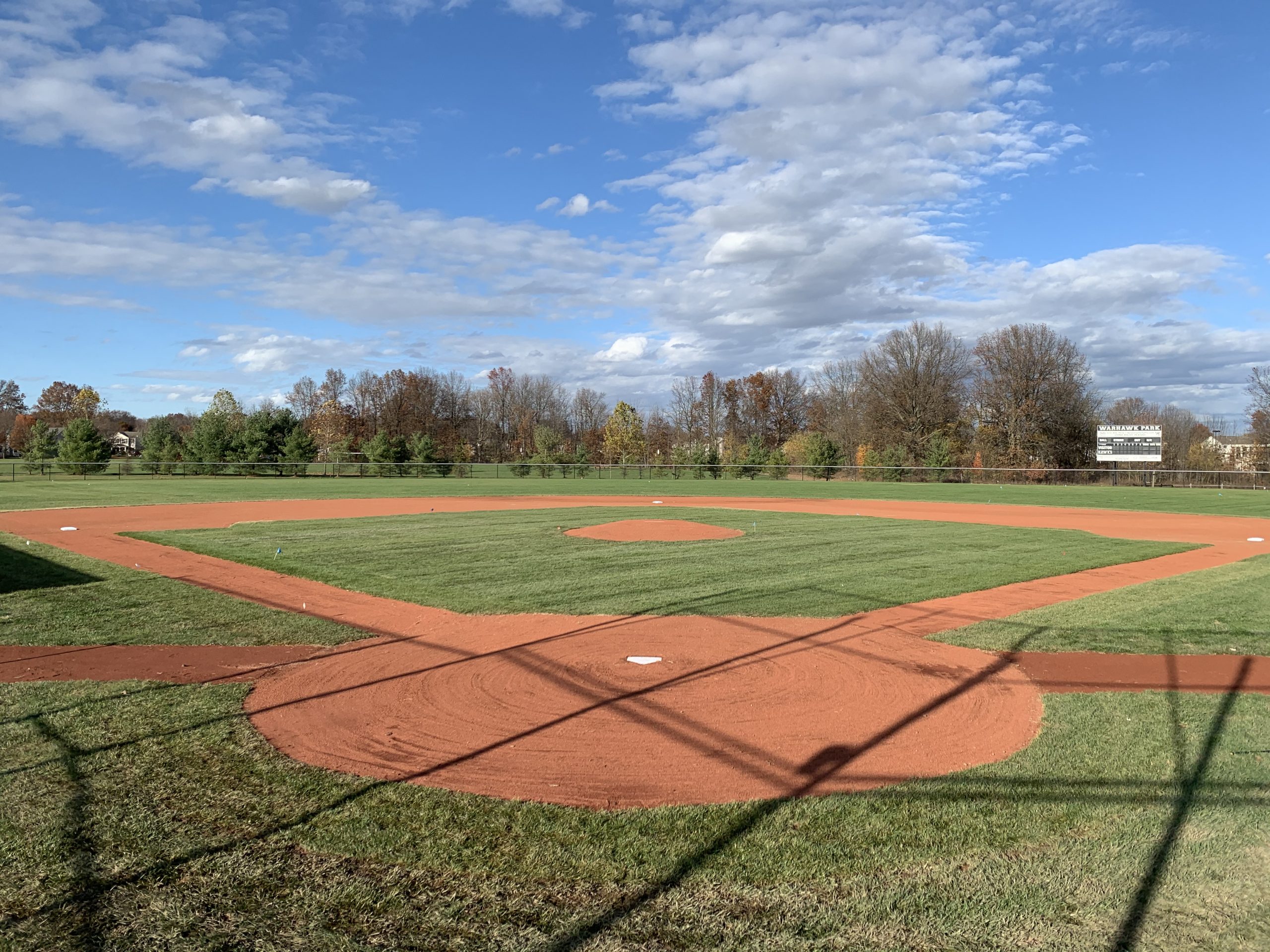 Basesball field with reddish infield skin and clean edges