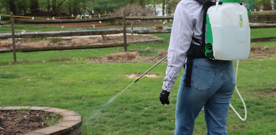 woman using FlowZone backpack sprayer