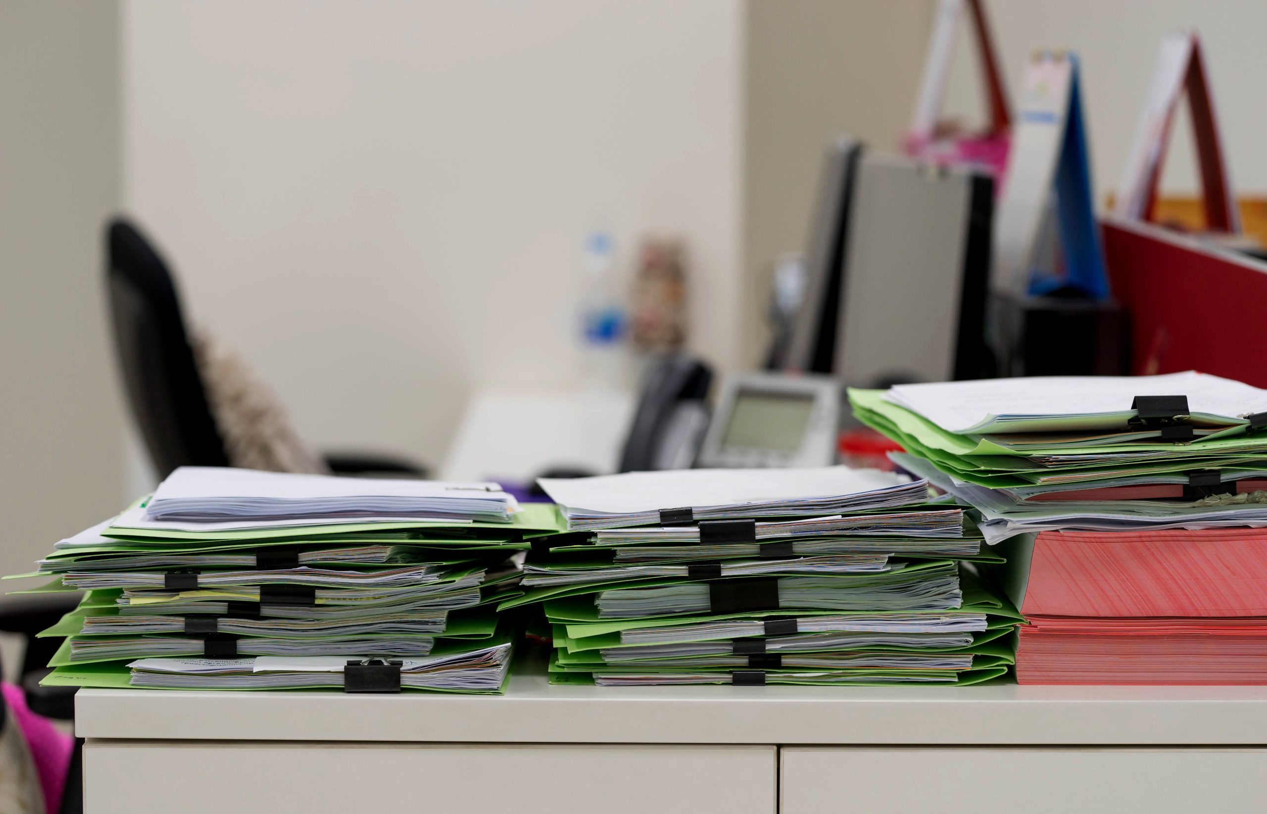 many paper documents on table in office