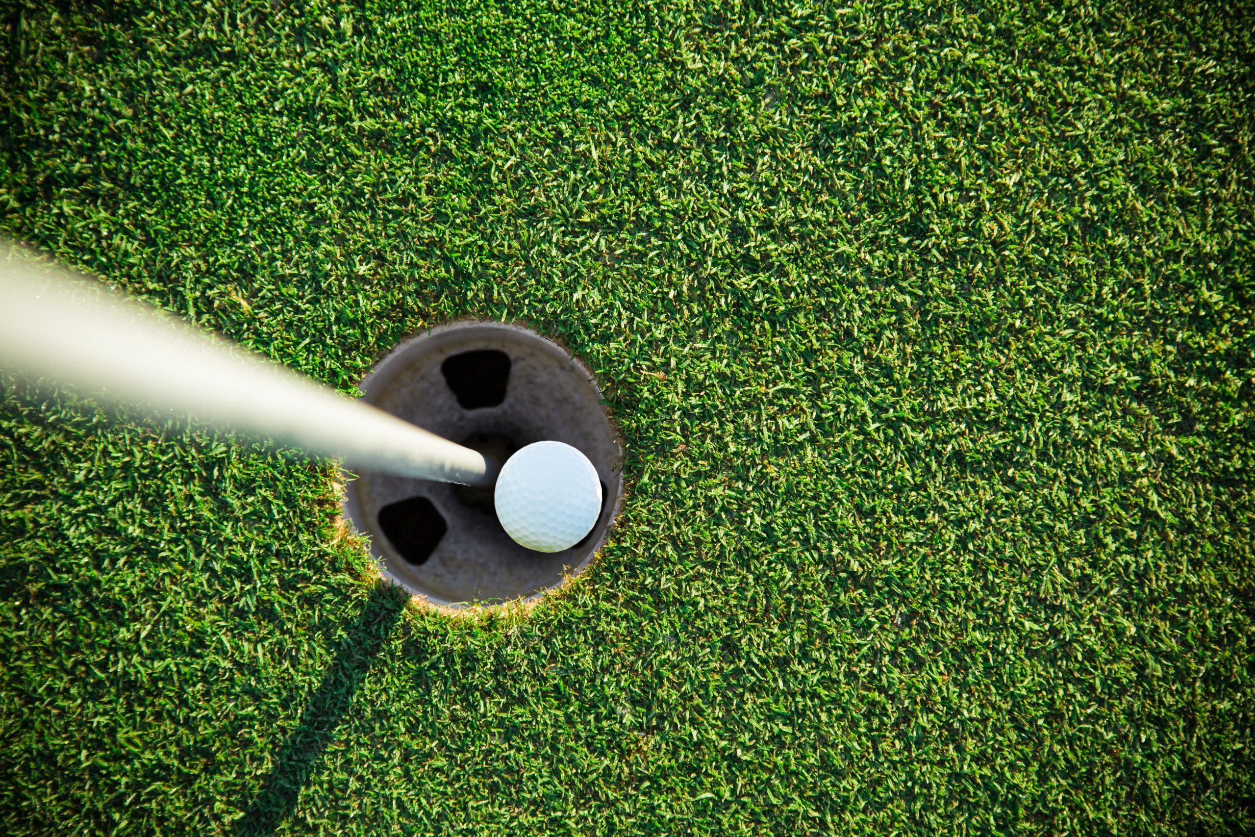 Close-up of golf ball during sunrise.