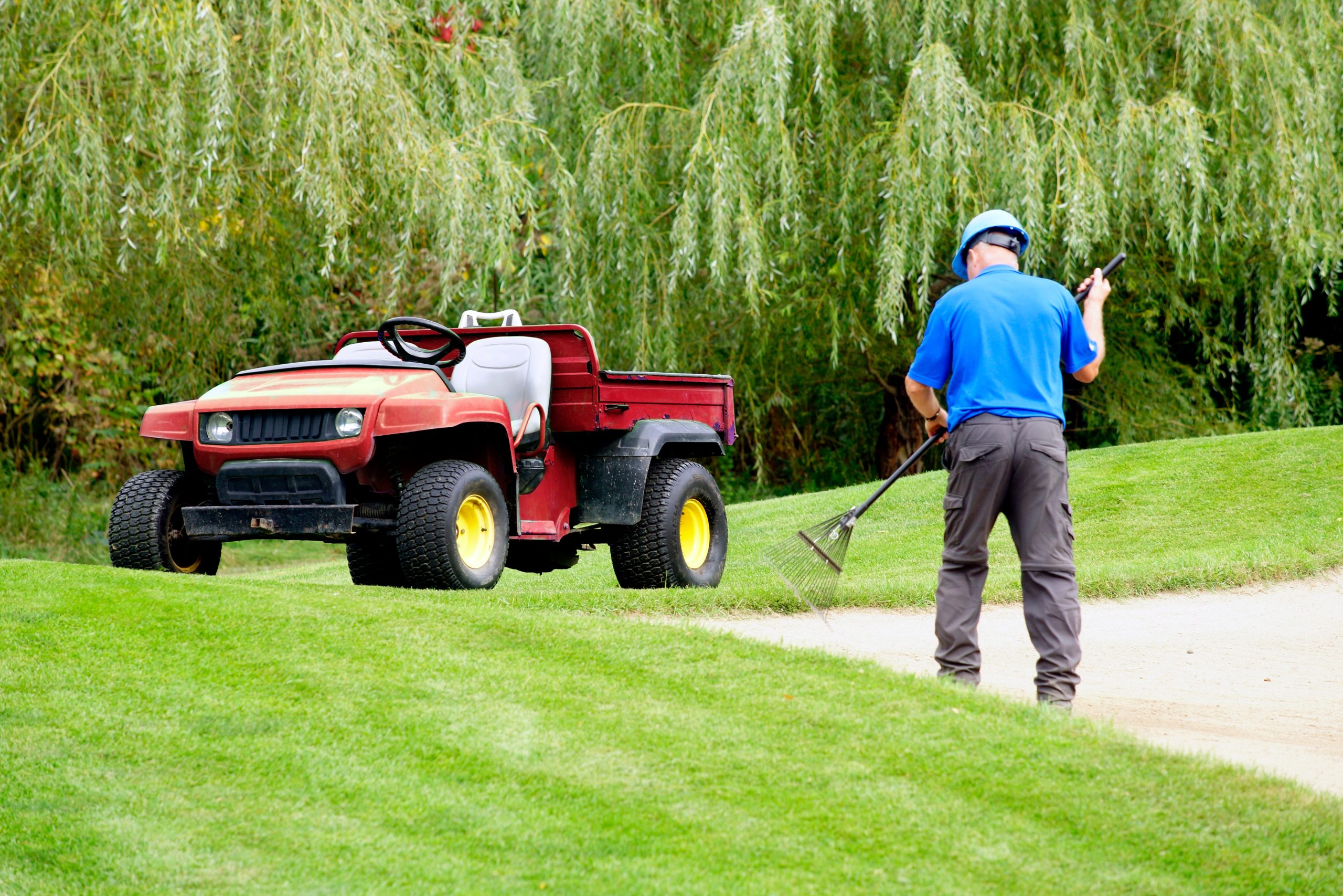 Golf groundskeeper at work on golf course