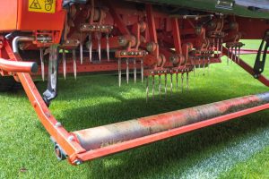 Detail of aeration machine during grasslands football field