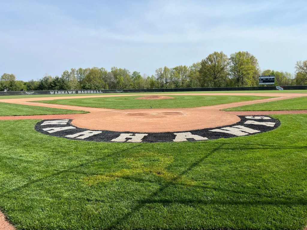 view from behind home plate with "Warhawks" painted on turf around home plate area