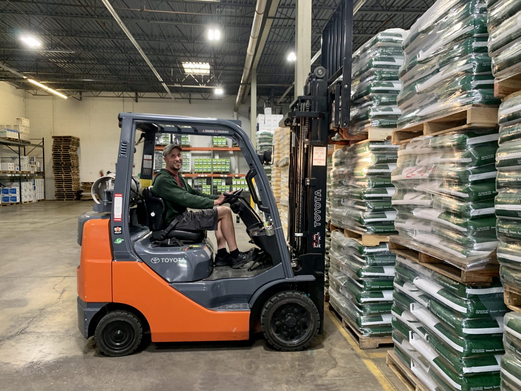 Man driving a forklift in a warehouse