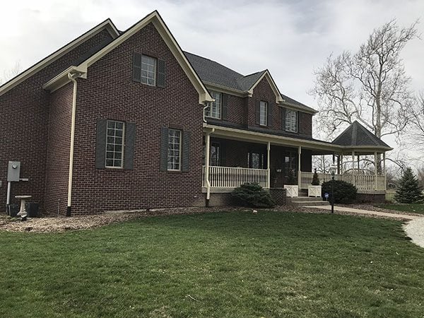 side view of large house with fresh green grass