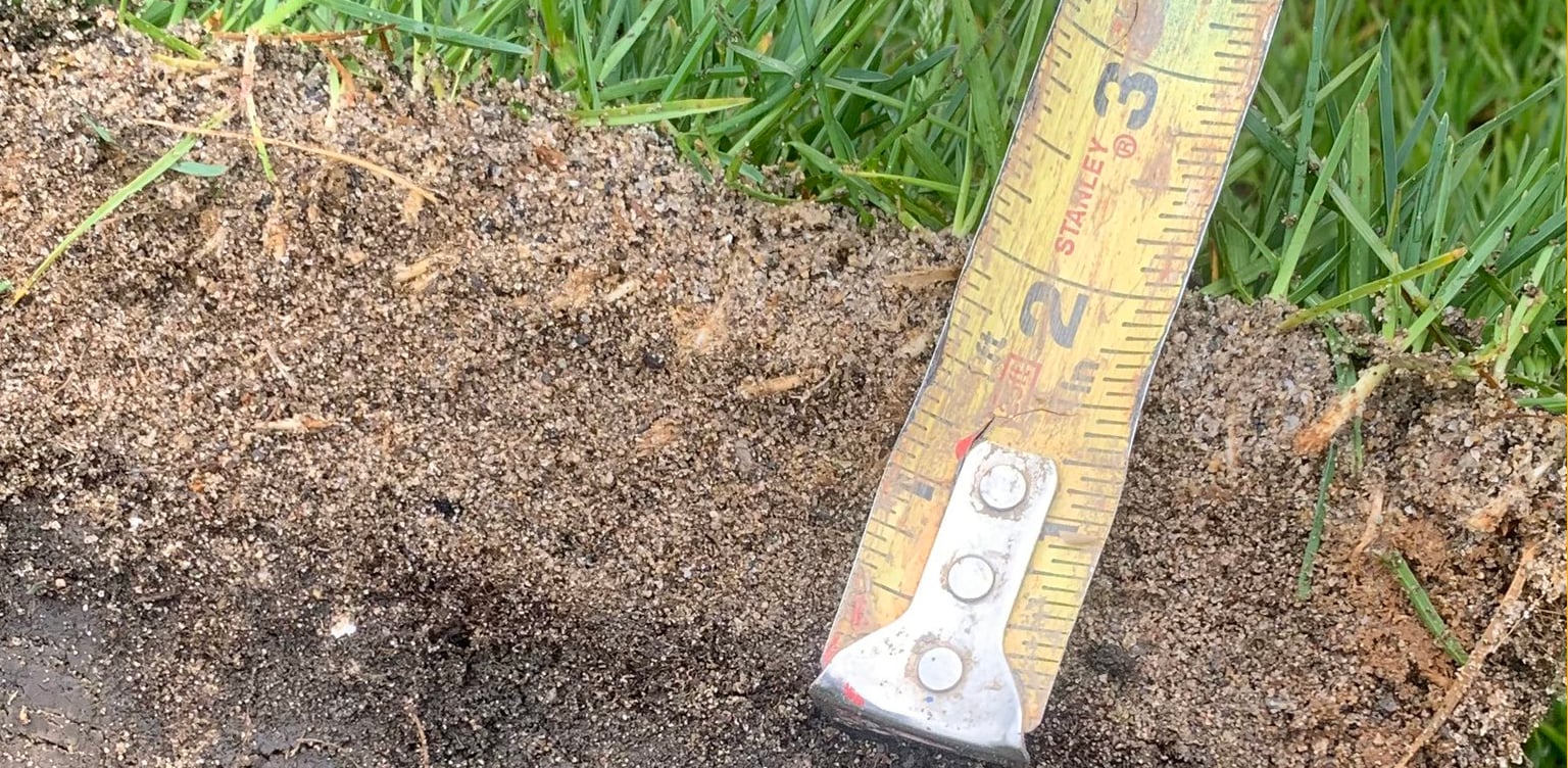 sandcap cross-section with ruler measuring depth